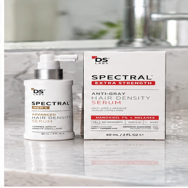 Spectral MEN’S junto a su caja sobre un lavamanos de mármol con gotas de agua.